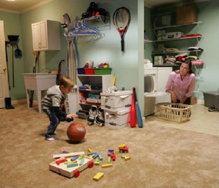 A family utilizing the laundry and play room after restoration