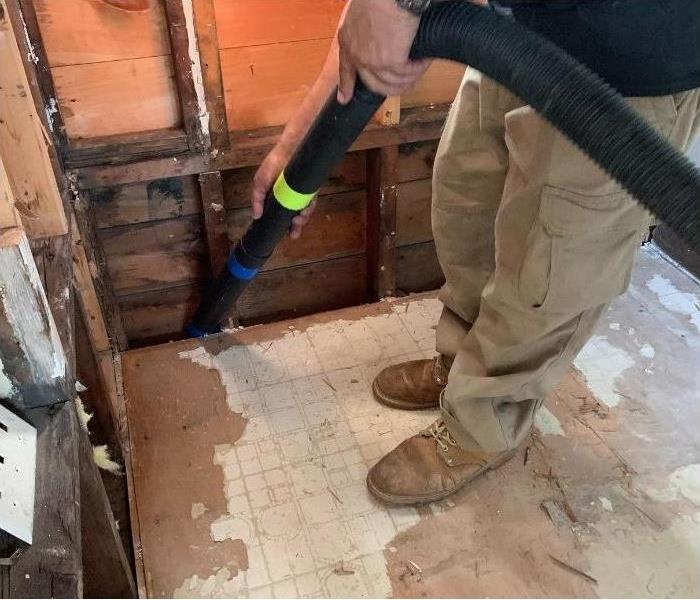 Our SERVPRO technician vacuuming and cleaning up the debris. 