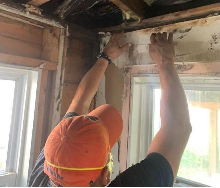 Our SERVPRO technician removing the molded/water damaged part of the wall.