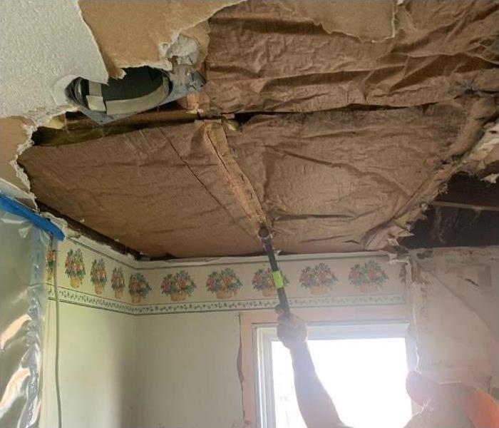 Removing more of the damaged ceiling to access all of the water damage.