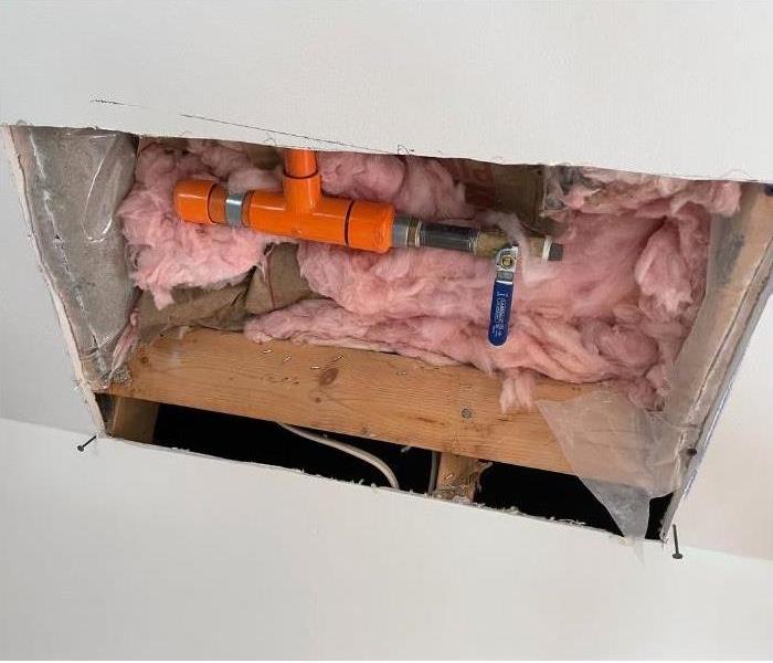 A hole cut into the ceiling of an Albany home exposing wet insulation.