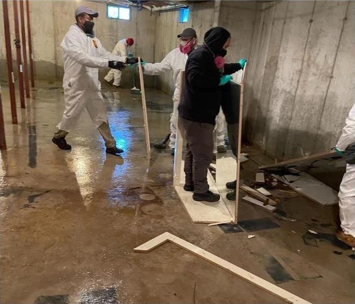 Our certified SERVPRO technicians working on cleaning a flooded basement.