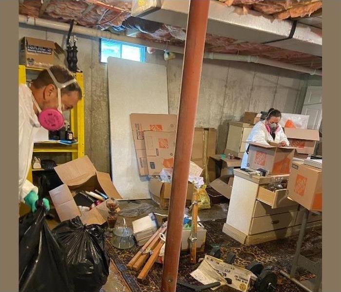 An Albany basement being cleared out by our SERVPRO professionals after a storm.