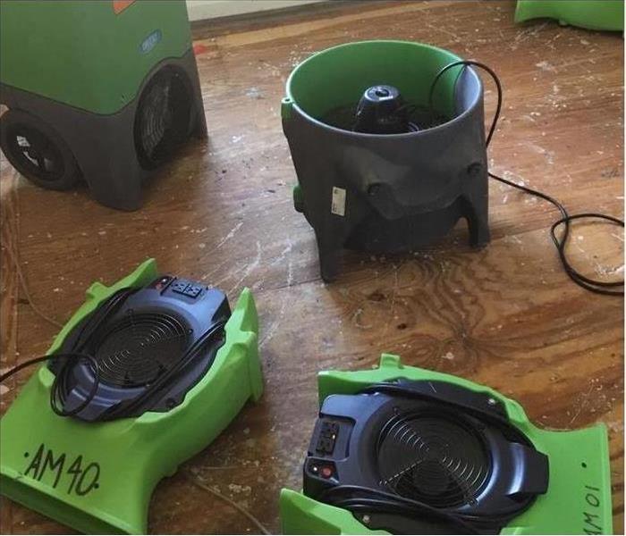 A water damaged floor with SERVPRO equipment 