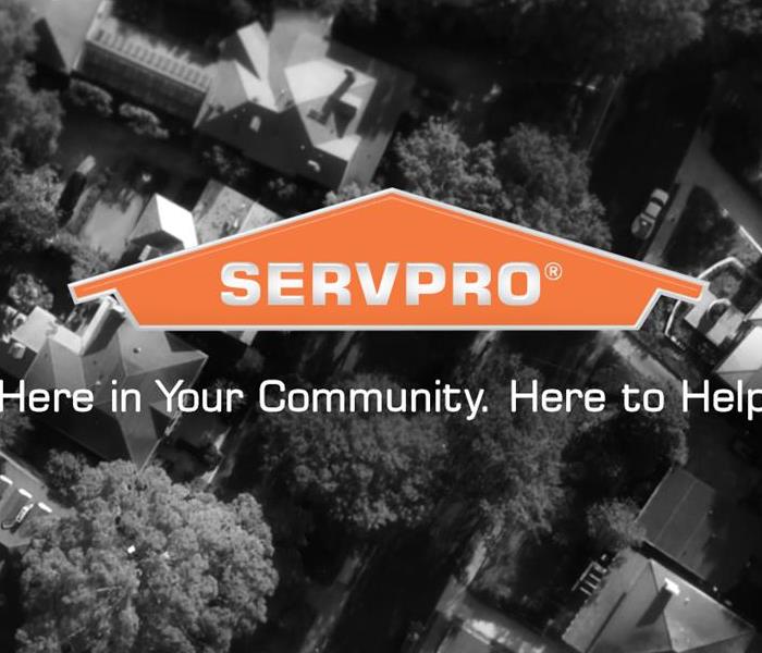 An aerial shot of a neighborhood with the SERVPRO logo and says "Here in Your Community. Here to Help."