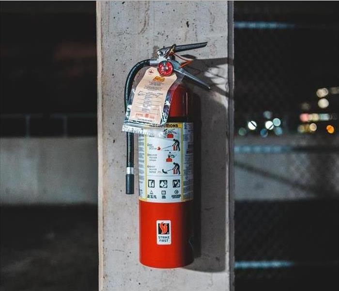 A fire extinguisher hung on a wall.